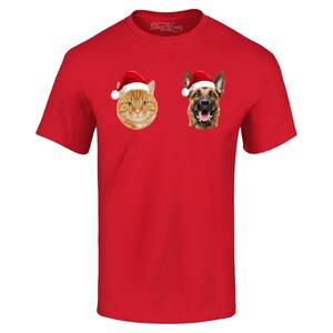 May include: Red t-shirt with a cat and dog wearing Santa hats. The cat is orange and white and the dog is brown and black.