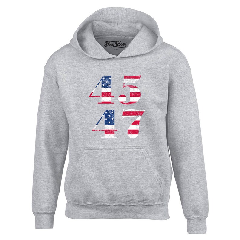 May include: A grey hooded sweatshirt with the numbers 45 and 47 printed on the front. The numbers are in a distressed style and are made up of the American flag.