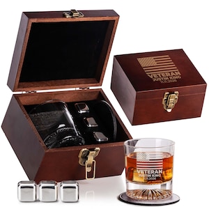 May include: A wooden whiskey gift set with a glass, whiskey stones, and a coaster. The glass and the wooden box lid feature an engraved American flag design with the text "VETERAN JUSTIN KING 11.11.2026". The set includes a wooden box with a clasp.
