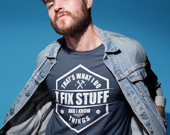 May include: A navy blue t-shirt with a white graphic of a hexagon with the text "That's What I Do I Fix Stuff And I Know Things" and a wrench and hammer inside the hexagon.