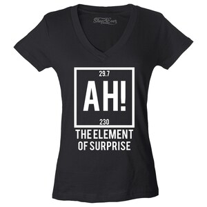 May include: Black V-neck t-shirt with white text and graphic. The graphic reads "AH!" with numbers above and below, and "THE ELEMENT OF SURPRISE" below. The shirt has short sleeves.