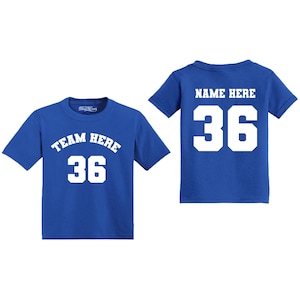 May include: Two royal blue t-shirts with white text. One shirt says "TEAM HERE 36" and the other says "NAME HERE 36".