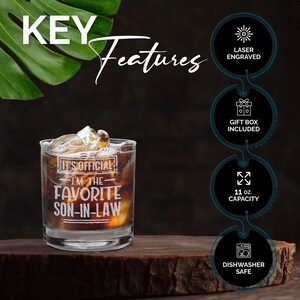 May include: A clear glass tumbler with the text "It's Official I'm the Favorite Son-in-Law" engraved on the front. The tumbler is filled with ice and a dark liquid. The tumbler is on a wooden surface. Key features include laser engraving, a gift box, 11 ounce capacity, and dishwasher safe.