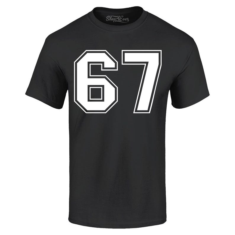 May include: Black t-shirt with the number "67" in white, outlined in black. The number is large and centered on the shirt. The brand name "Shop4ever" is printed at the top.