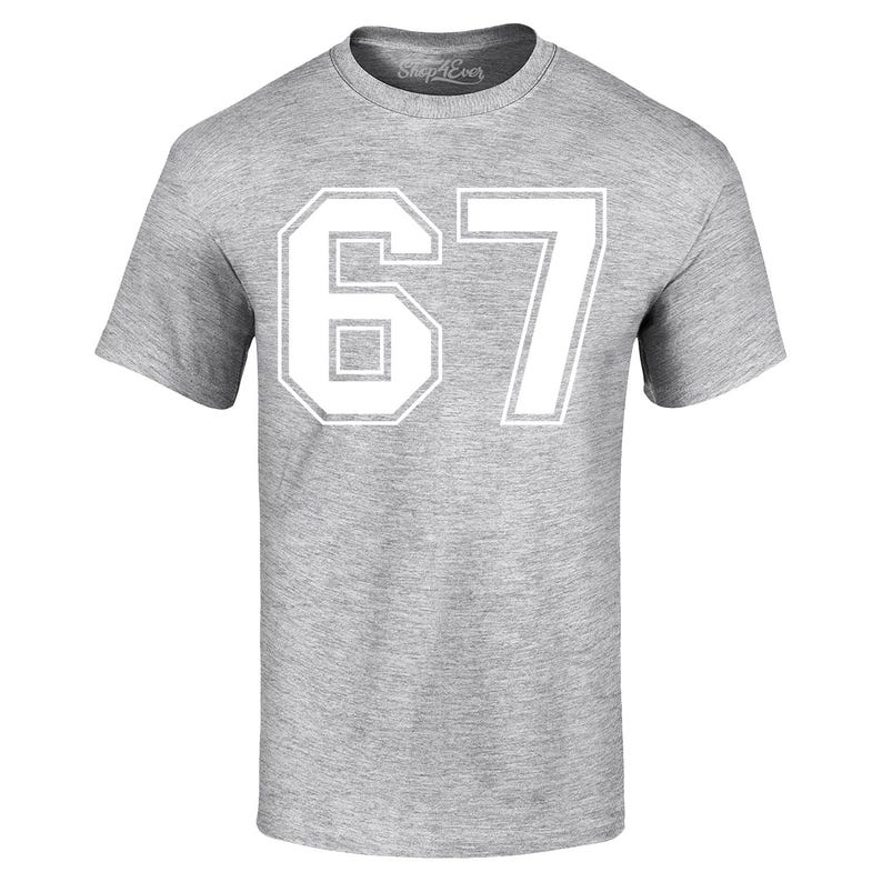May include: A heather gray t-shirt with the number "67" printed in white. The number is in a block style with a white outline. The shirt has short sleeves and a crew neck. The brand name "Shop4Ever" is printed on the collar.
