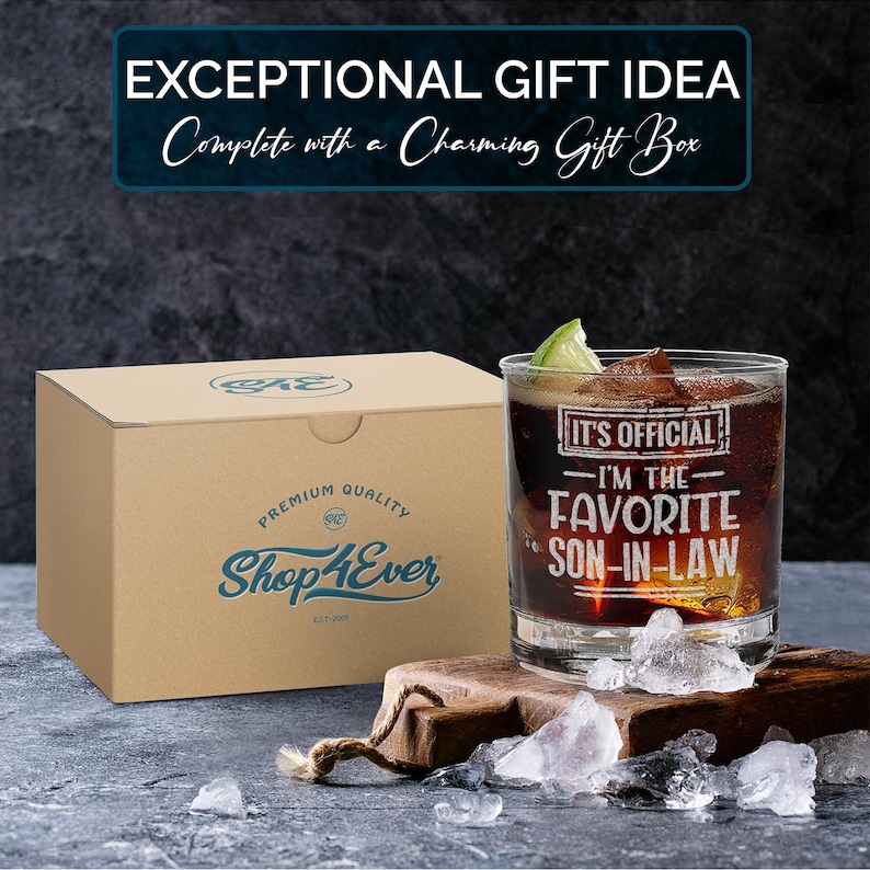 May include: A brown cardboard box with the text "Shop4Ever" and "Premium Quality" printed on it. A clear glass with the text "It's Official - I'm the Favorite Son-in-Law" is sitting on a wooden surface with ice cubes.