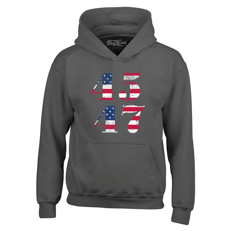 May include: A dark grey hooded sweatshirt with the numbers 45 and 47 printed on the front. The numbers are in a white font and are decorated with an American flag design.