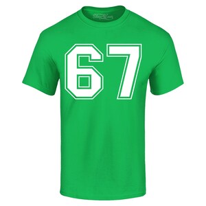 May include: A bright green t-shirt with the number "67" printed in white. The number is large and centered on the shirt, with a bold, outlined font. The shirt has a crew neck and short sleeves.