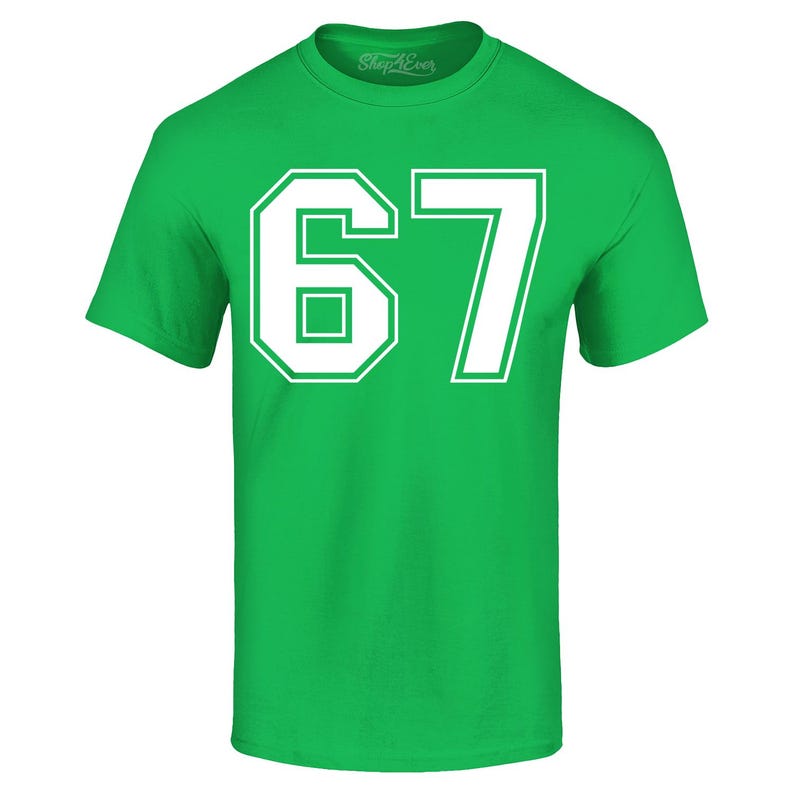 May include: A bright green t-shirt with the number "67" printed in white. The number is large and centered on the shirt, with a bold, outlined font. The shirt has a crew neck and short sleeves.