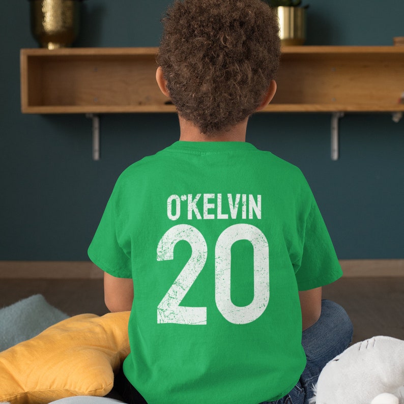 Make St. Patrick’s Day extra special with this Custom Irish Shamrock Kids’ T-Shirt! Personalize it with your child's name and jersey number for a unique and festive look. Perfect for parades, school events, and family celebrations, this customizable Irish Day shirt is a great gift for kids who love to show their Irish pride!