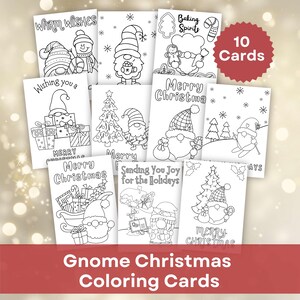 May include: A set of 10 black and white printable Christmas coloring cards featuring gnomes, holiday trees, gifts, and text including Warm Wishes, Baking Spirits, Merry Christmas, and Sending You Joy for the Holidays. The cards are arranged in a grid.