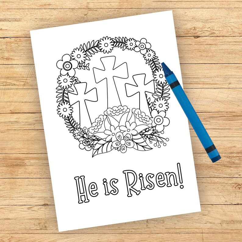 Może przedstawiać: Czarno-biała strona do kolorowania przedstawiająca trzy krzyże otoczone wieńcem kwiat&oacute;w. Pod krzyżami widnieje napis "He is Risen!"