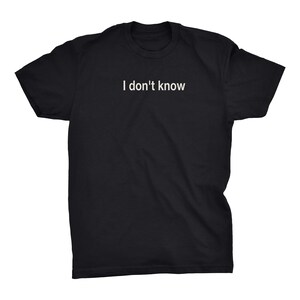 May include: A black short-sleeved t-shirt featuring the text "I don't know" printed in white across the center of the chest. The garment has a crew neckline and a standard fit, showcasing a simple design with clear, legible white lettering.