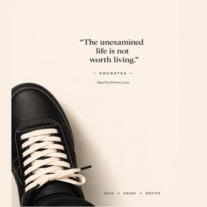 May include: Black leather sneaker with white laces and stitching. The image includes the quote "The unexamined life is not worth living." by Socrates, with the text "READ • PAUSE • NOTICE" at the bottom.