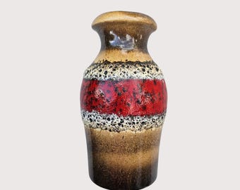 May include: A ceramic vase with a brown, red, and beige color scheme. The vase has a bulbous shape with a narrow neck and a flared rim. The design includes horizontal bands of color and texture, creating a unique decorative piece.