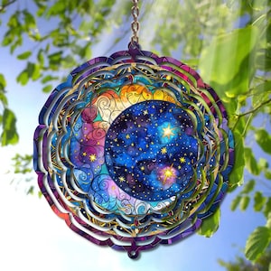 May include: A colorful metal wind spinner with a mandala design featuring a crescent moon and stars on a blue background. The wind spinner has multiple layers and is designed to spin in the wind.