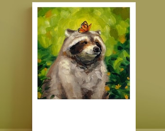 May include: An oil painting print featuring a raccoon with grey and white fur sitting amidst green foliage and yellow flowers. A small orange and black butterfly is perched on top of the raccoon's head. The artwork has a white border frame.
