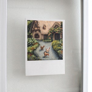 May include: A rectangular art print featuring an oil painting of a cottage with a thatched roof, a stone path, and three chickens in the foreground. The scene includes lush green foliage, colorful flowers, and a birdhouse on the cottage wall.