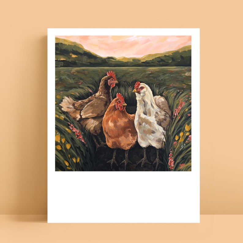 May include: A painting featuring three chickens standing in a grassy field with wildflowers. The chickens are brown, orange, and white, each with a red comb. The background shows rolling green hills under a soft pink and orange sunset sky.