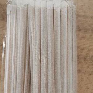 May include: A package of 25 brown paper straws wrapped in clear plastic.