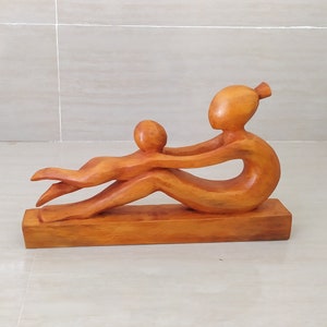 Mother & Child Wooden Sculptures at play