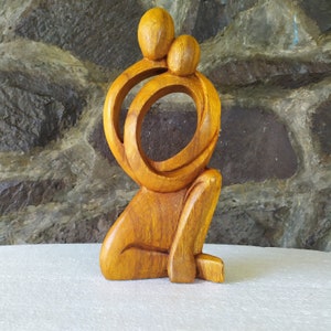 Abstract wooden statue of a loving couple hugging passionately. Dancing Couple Statue. valentines gift.