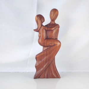 Romantic couple wooden statue, abstract statue of a boy holding a girl.