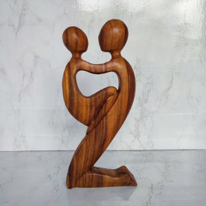 Abstract statue of father holding his son
