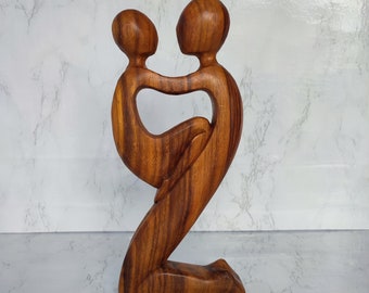 Abstract statue of father holding his son