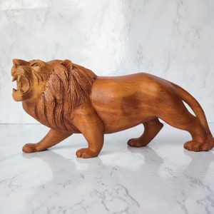 Hand carved lion statue from natural wood 30 cm