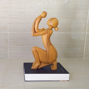 Abstract statue of mother communicating with her baby.