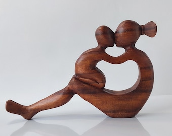 statue of mother and child playing.