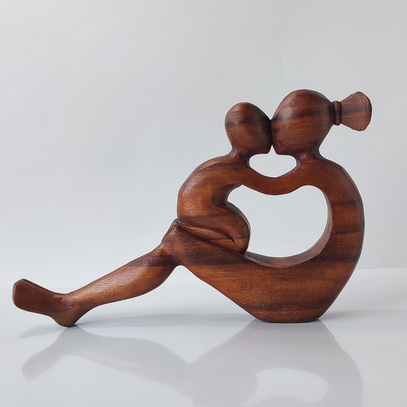 statue of mother and child playing.