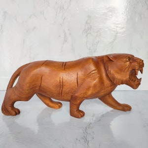 Hand carved tiger statue in natural wood 30 cm