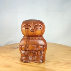 Japanese jizo Buddha statue carving made of natural wood for your home and garden decoration.