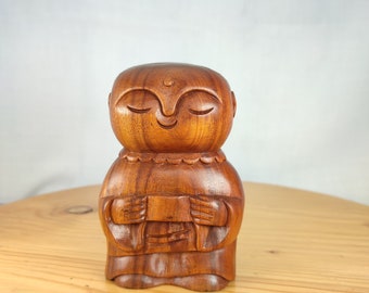 Japanese jizo Buddha statue carving made of natural wood for your home and garden decoration.