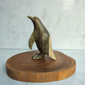 Hand carved penguin statue of natural wood