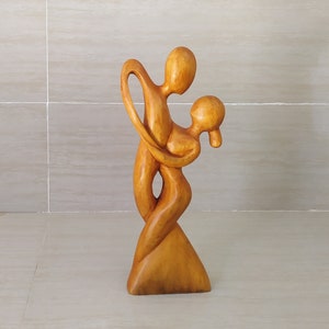 Abstract Wooden Sculpture Couple Dancing tanggo calmly and gracefully. Dancing Couple Wood Sculpture. love statue.