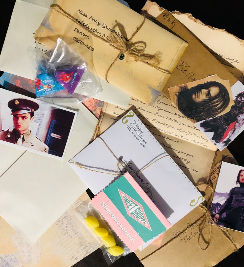 May include: A collection of vintage-style envelopes, handwritten letters, and printed photographs featuring a person in a military uniform and a long-haired figure. Includes small plastic bags of sweets labelled Sweet Shoppe Sherbet Lemon.