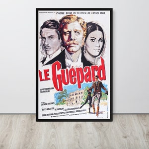 May include: A vintage movie poster for the film "The Leopard" (Le Guépard) in Italian. The poster features a red and white title with the names of the actors Burt Lancaster, Alain Delon, and Claudia Cardinale. The poster also includes the text "Palme d'Or du Festival de Cannes 1963" and "Supertechnirama Technicolor".
