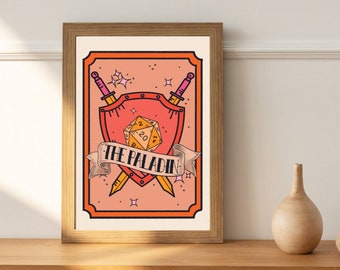 May include: A framed print with a pink and orange illustration of a shield with a 20-sided die, two crossed swords, and the text "THE PALADIN".