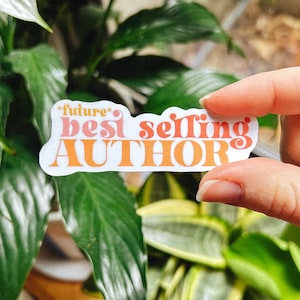 May include: A white sticker with orange and pink text that reads "future* best selling AUTHOR".