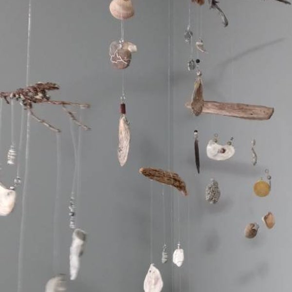 Custom made mobiles featuring rocks shells and charms collected from beaches all over the world