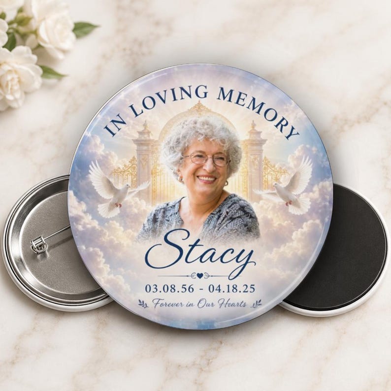 May include: A round memorial button with the text "IN LOVING MEMORY" and a photo of a smiling woman named Stacy. The button includes the dates 03.08.56 - 04.18.25 and the phrase "Forever in Our Hearts."