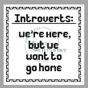 May include: Square white cross-stitch design with a black border. The text reads "Introverts: we're here, but we want to go home" in a pixelated font. A circular logo with text is in the centre.