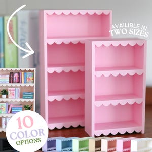 May include: Two pink wooden mini bookshelves with scalloped edges on each shelf. The text reads mini BOOKSHELF, AVAILIBLE IN TWO SIZES, and 10 COLOR OPTIONS. A smaller inset image shows a filled bookshelf with miniature books and small potted plants.