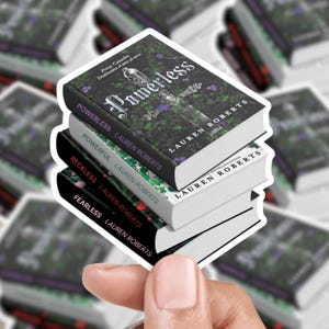 May include: A stack of four book stickers with white borders. The top book is titled "Powerless" with a dark cover and the author's name, Lauren Roberts. The other books are titled "Powerful", "Reckless", and "Fearless".