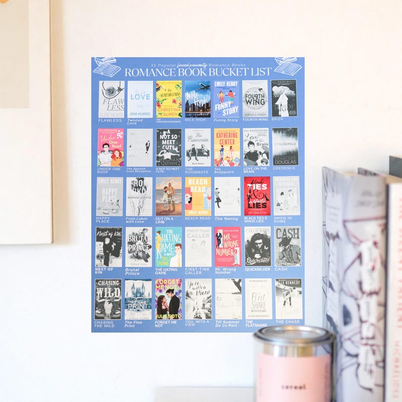 May include: A blue poster titled "Romance Book Bucket List" featuring book covers. The poster includes titles like "Love," "Funny Story," and "Fourth Wing." The poster is displayed on a white wall, with a candle and books in the background.