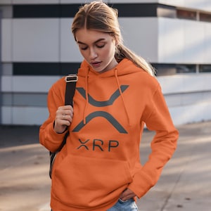 May include: A bright orange hoodie with a gray XRP logo and text. The hoodie has a drawstring hood and a kangaroo pocket.