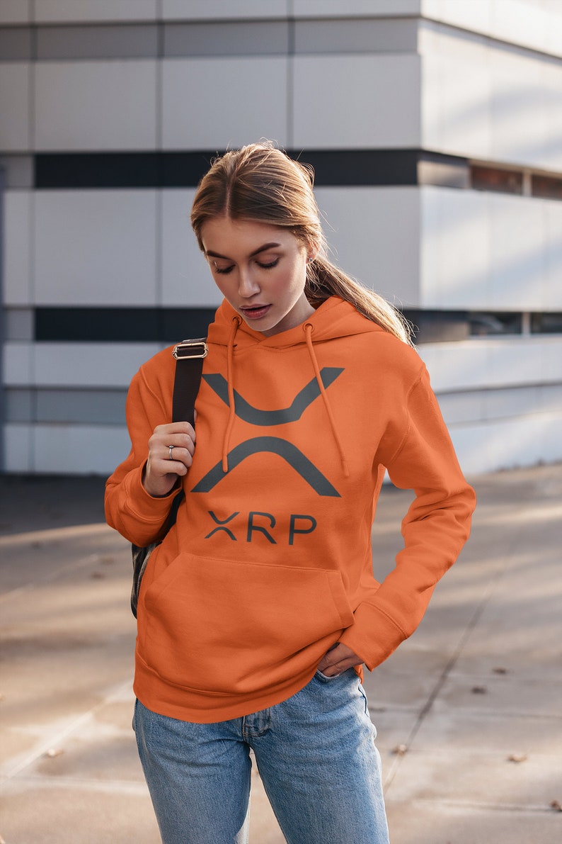May include: A bright orange hoodie with a gray XRP logo and text. The hoodie has a drawstring hood and a kangaroo pocket.